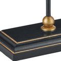 Close-up detail of round gold accent connecting lamp stem to base