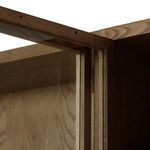Cabinet corner with metal door hinge in aged bronze finish and oak wood panels
