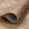 Close-up of Anniston Clay Charcoal rug curling at corner showing woven polyester texture and backing