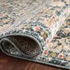 Folded corner close-up highlighting soft polyester pile texture and backing of Saban Blue Spice rug