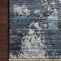 Modern Samra Dove / Sky Rug with abstract blue, gray, and white pattern and fringe edge on wood floor