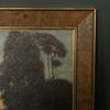 Close-up of textured painting surface and wood grain frame corner