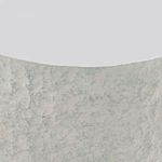 Close-up detail of the rough, faux stone texture of the Pincio side table surface