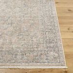 Edge detail of Maria Brown/Ivory Elena rug with visible woven fringe and subtle color variations on wood floor