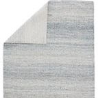 Top view of corner folded back revealing rug’s subtle striped backing detail