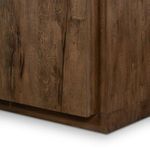 Close-up at base corner illustrating tight wood joinery and finished plinth