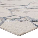 Close-up showing striated cut and looped pile texture in neutral abstract pattern