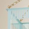 Top corner detail emphasizing scalloped and slatted metalwork and brass chain on Soft Arctic Blue Rosalie Lantern