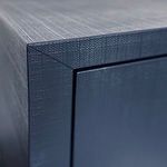 Detailed close-up of navy blue textured finish at the chest’s top corner edge with visible grain