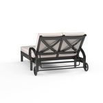 Rear view highlighting cross back design and metal frame details with wheels on Monterey Double Chaise