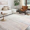 Lucia Mist Rug styled in a modern living room with white sofa, brown leather chair, and light wood floor