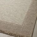 Angled close-up emphasizing contrast in weave patterns and color tones near fringe