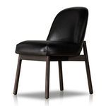 Side angled view of black leather armless dining chair showing seat depth and curved backrest