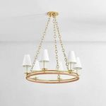 Close-up of chandelier’s aged brass ceiling mount with triple chain suspension and upper aged brass ring