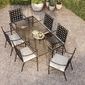 Overhead view of six Provence Dining Chairs surrounding a long glass-top outdoor dining table on gravel