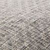 Close-up of woven cotton fabric showing textured tribal diamond pattern in light grey and beige tones