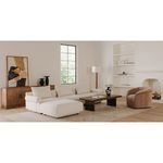 Thora Lounge Chair styled in a living room with white sectional sofa, wooden coffee table, and minimalist decor
