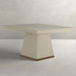 Square dining table with white-cerused veneer finish, angled tapered base, and gold-toned banding at base
