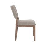 Side view of Phillip Dining Chair showing upholstered back panel and seat supported by wooden frame and tapered legs