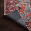 Loren Blue / Red Rug corner lifted to show the tightly woven rug backing on hardwood floor