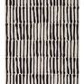 Hand tufted black and ivory wool rug featuring bold vertical tribal-inspired stripes and knotted fringe ends