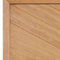 Close-up showing chamfered edge framing the wood grain of angled pattern on door