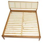 Overhead view displaying wooden slat bed base and woven headboard from above