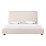 Front view of bed with white bedding and two pillows on padded headboard