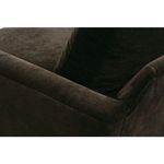 Side detail close-up of armrest and back cushion seam in dark velvet fabric