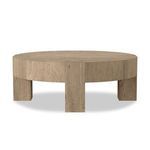Low round coffee table facing forward, showcasing three chunky squared legs and dovetail joinery