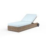 Outdoor adjustable chaise lounge with aged tobacco all-weather wicker base and light blue cushions