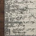 Close-up of a corner on dark hardwood floor emphasizing the rug's grey border detail