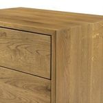 Darker wood grain detail on top corner edge of stained oak nightstand