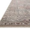 Low angle side view displaying rug's thin pile and softly fringed edge