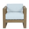 Front view showing broad armrests and wide light blue seat and back cushions on teak chair