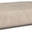 Ottoman shown from a lower angle highlighting its thick cushioning and dark base trim