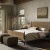 Kylo Ottoman placed in a bedroom setting near bed with natural light coming through sliding door