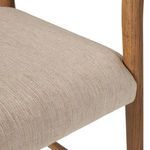 Angled close-up view of cushioned seat corner and side wooden leg connection