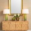 Styled room setting with Beau cabinet beneath gold framed mirror and flanked by green gradient lamps