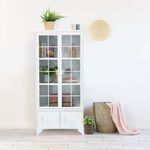 Oxford Glass Door Cabinet styled in a room with decorative objects and textiles around it