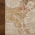 Edge corner of the rug lying flat on dark hardwood flooring highlighting binding and woven texture
