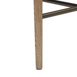 Close-up of tapered wooden leg with visible wood grain and bronze metal support