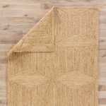 Top view with rug corner lifted revealing underside and weave consistency