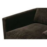 Close view of seat cushion and armrest corner showing dense soft fabric