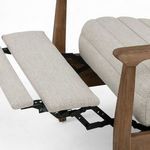 Close-up of extended footrest showing upholstery and black metal reclining hardware