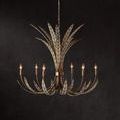 Chandelier lit with all six bulbs glowing, against a dark wall