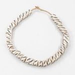 Kenya cow bone bead string arranged circularly showing subtle cracks and color variations along beads