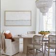 Shelter Slipcover Arm Chair styled at dining table with woven chairs, neutral tones, and natural light