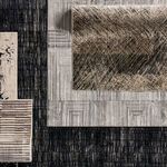 Overhead view of Dairon rug layered with other geometric and textured rugs for contrast
