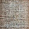 Overhead view showing full rectangular rug design with intricate worn vintage pattern and muted colors